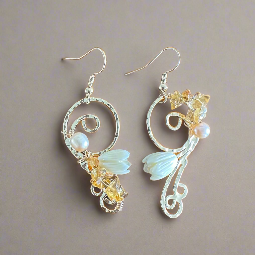 Pair of decorative earrings on a wooden surface