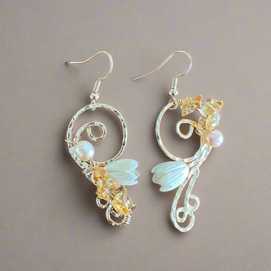 Pair of decorative earrings on a wooden surface